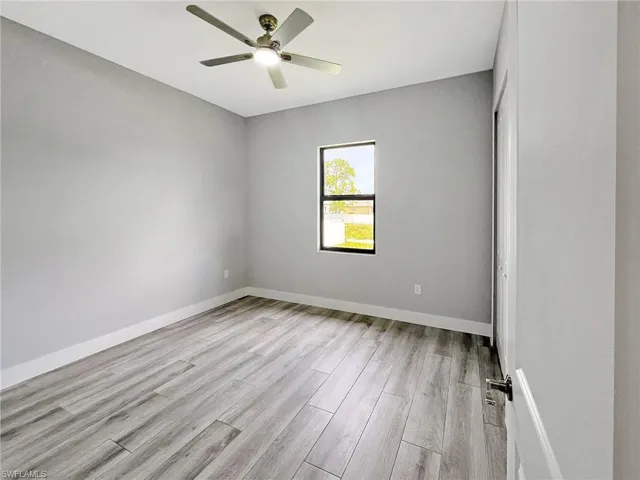 Empty room featuring light wood-type flooring and ceiling fan