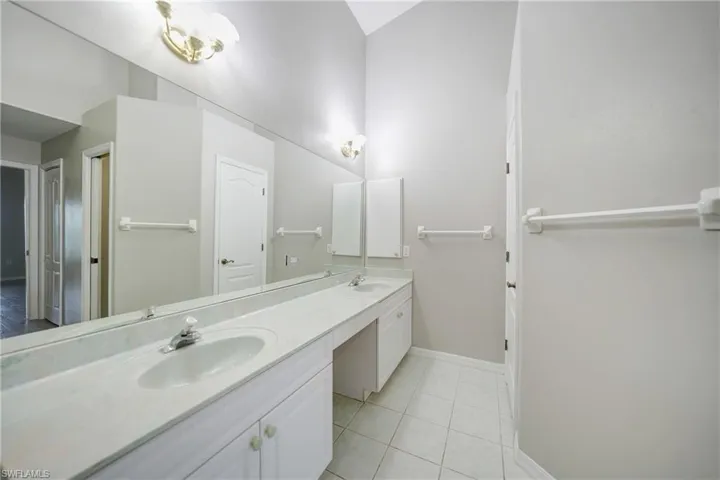 Bathroom featuring dual vanity and tile floors