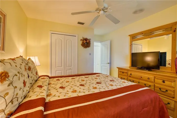 Bedroom with a ceiling fan and a closet
