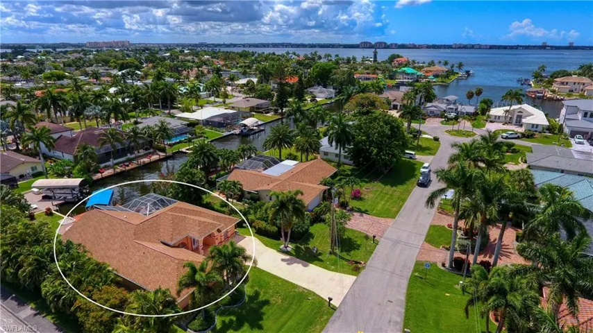 Aerial view of residential area featuring a nearby body of water