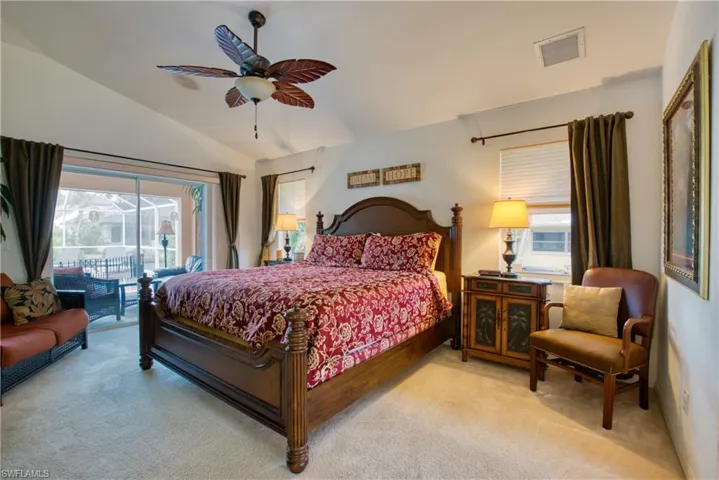 Carpeted bedroom with lofted ceiling, access to outside, and ceiling fan