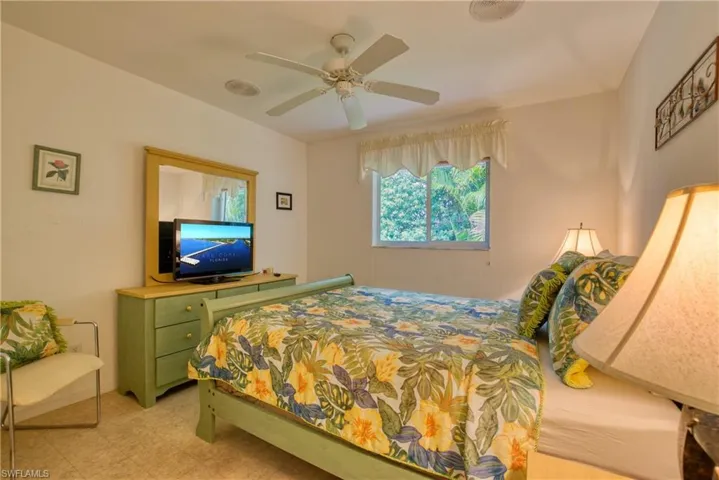 Bedroom with light floors and ceiling fan