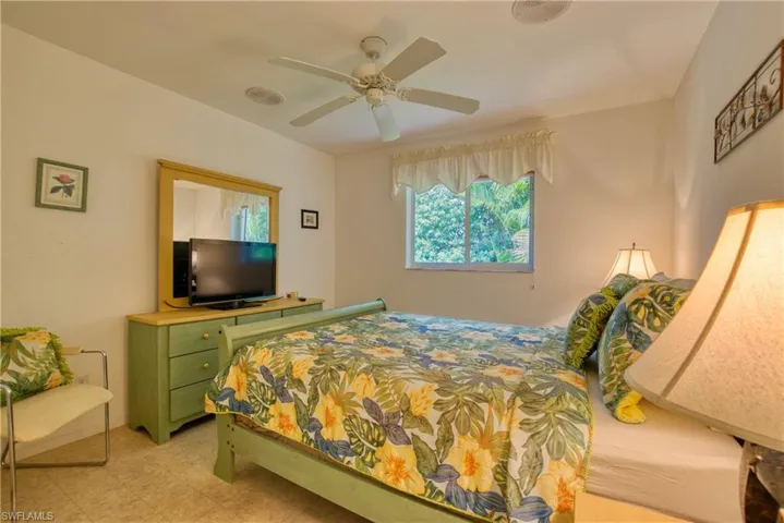 Bedroom featuring light flooring and a ceiling fan