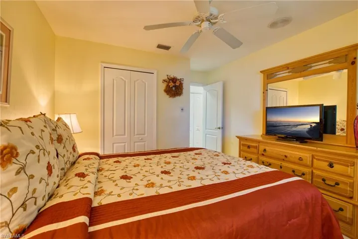 Bedroom featuring ceiling fan and a closet