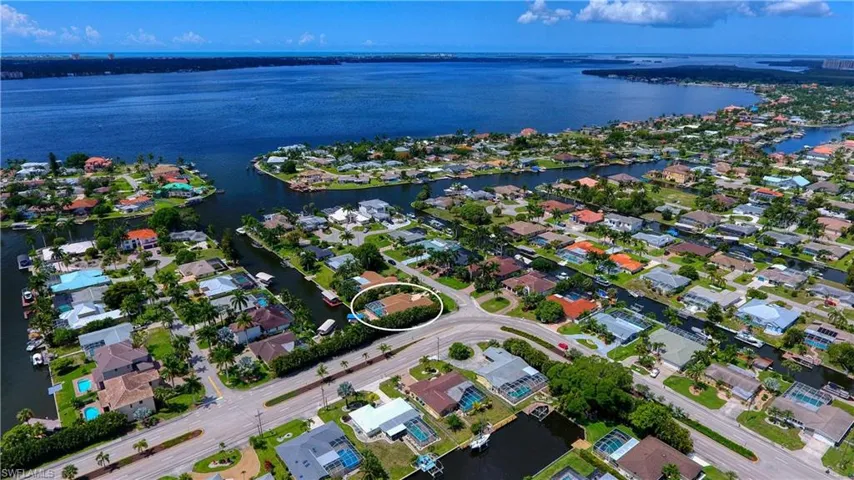 Aerial overview of property's location featuring nearby suburban area and a nearby body of water