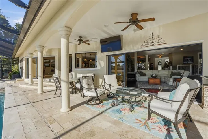 Entertain in style around the pool with plenty of under cover space on this show-stopping lanai. The mounted TV stays with the home.