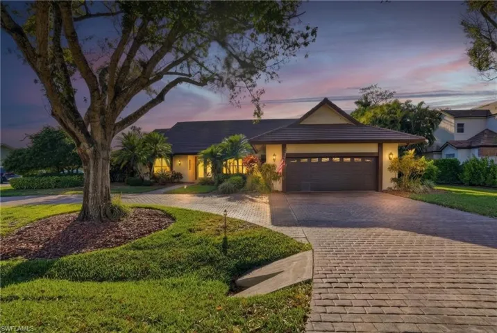 Beautiful curb appeal with the circular drive, mature trees and lush landscaping.