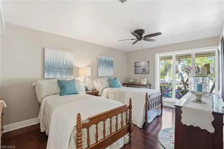 Guest room en-suite has cherry wood floors, ceiling fan, landscape views.