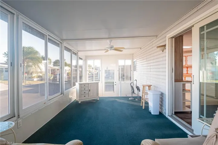 Sunroom featuring plenty of natural light, ceiling fan, and beam ceiling