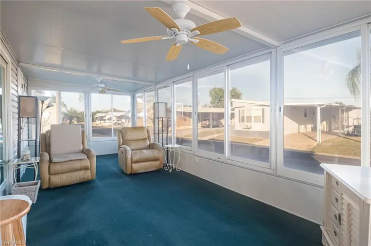 Sunroom / solarium featuring ceiling fan