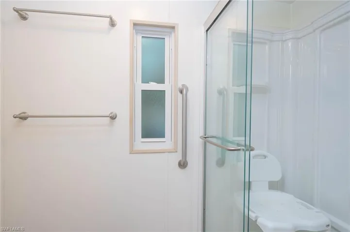 Bathroom featuring a shower with door
