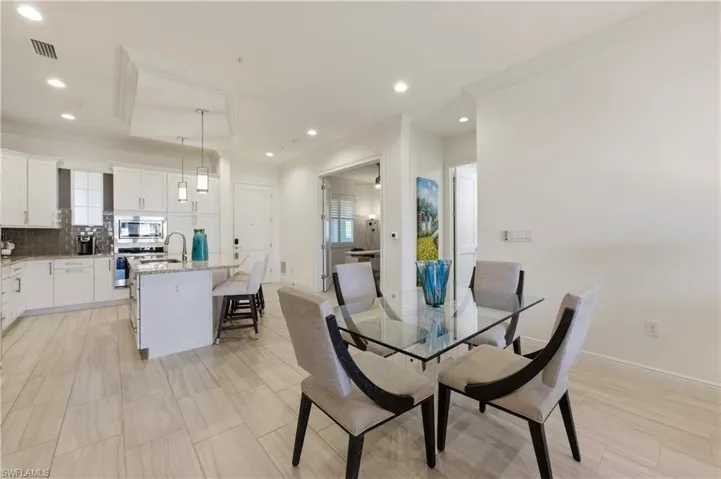Dining area featuring crown molding and recessed lighting
