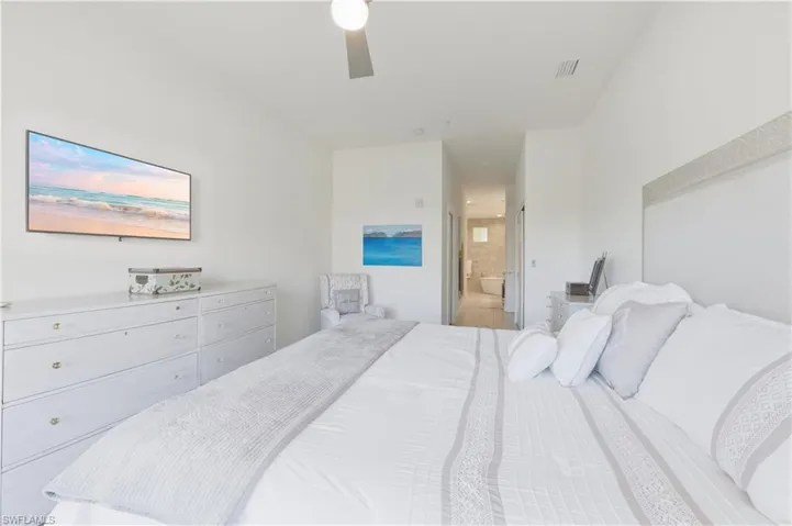 Bedroom with ceiling fan and ensuite bath