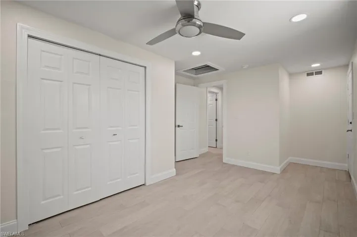 Unfurnished bedroom with light wood-type flooring, a closet, recessed lighting, and ceiling fan