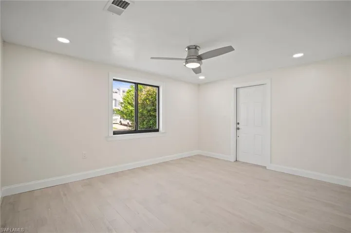 Empty room with light wood-type flooring, a ceiling fan, and recessed lighting