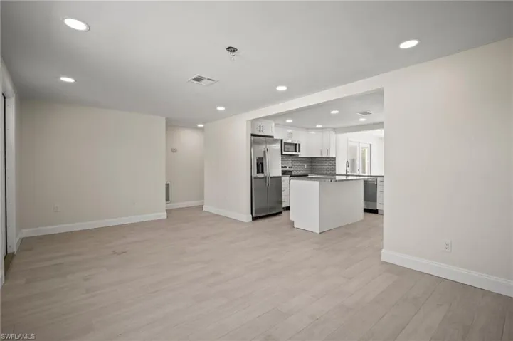 Unfurnished living room with light wood-type flooring and recessed lighting
