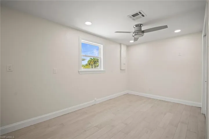 Unfurnished room with ceiling fan, light wood-type flooring, and recessed lighting