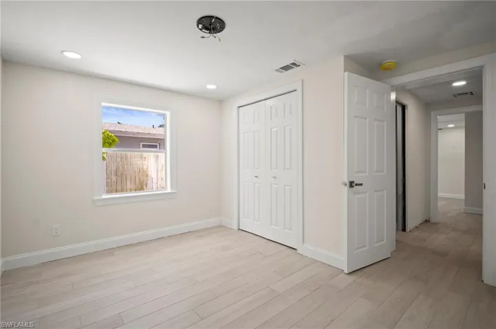 Unfurnished bedroom with light wood-style flooring, a closet, and recessed lighting