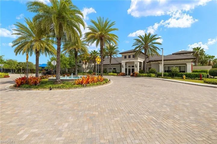 View of building exterior featuring curved driveway