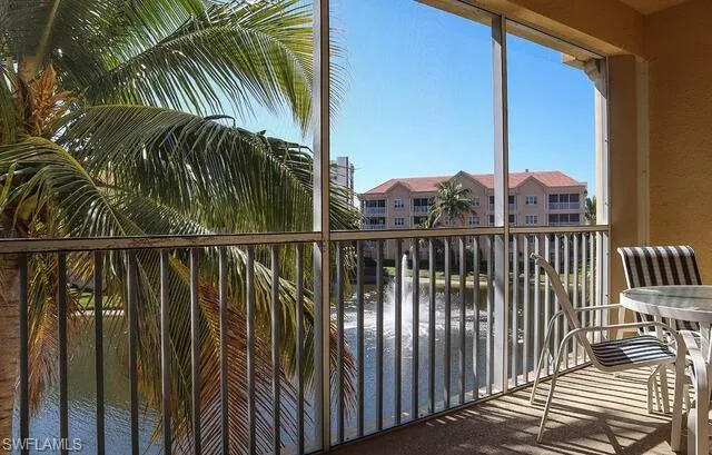 Balcony with a sunroom and a water view
