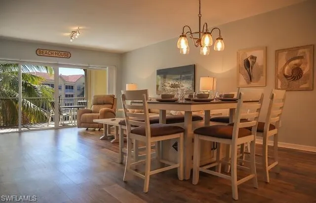 Dining room featuring dark wood finished floors and suspended lighting