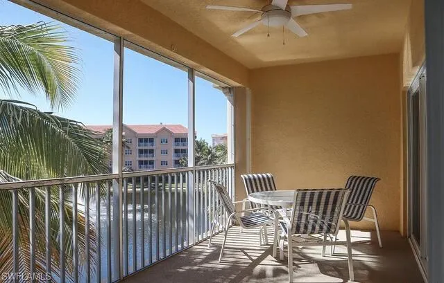 Balcony with a sunroom and a ceiling fan