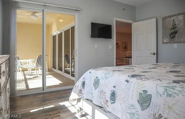 Bedroom with dark wood-style flooring and ceiling fan