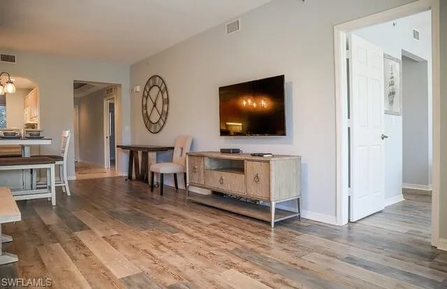 Living room featuring light wood-style flooring and baseboards