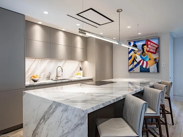Custom cabinetry with cabinet face appliances, island with 6cm edges and waterfall sides, concealed linear ductwork