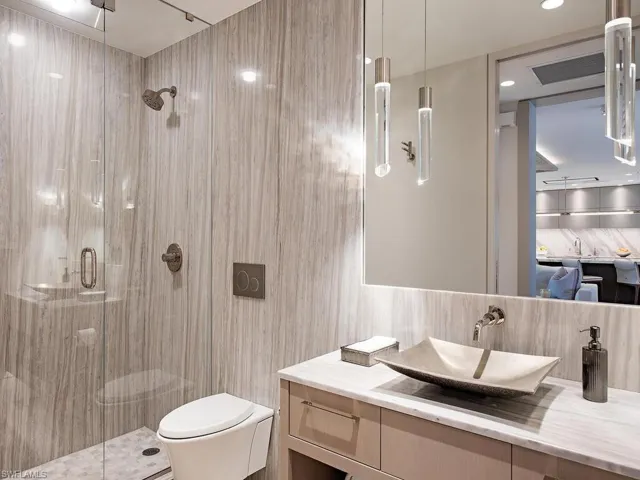 Floor to ceiling porcelain, StoneForest sink, the photo does not do this room justice.