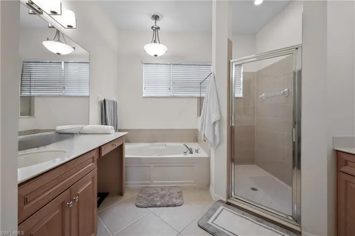 Owners bathroom has split vanities and separate tub and shower.