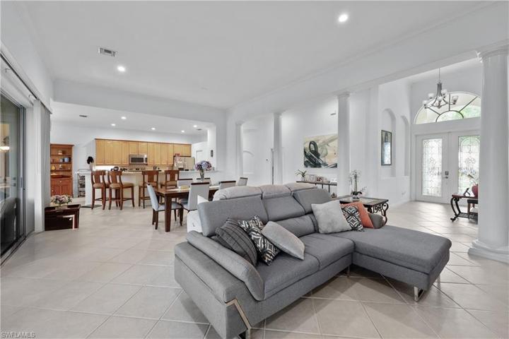 Huge great room with high ceilings, tile on the diagonal, LED lighting.
