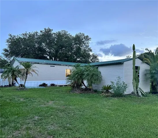View of front of house featuring a front yard and a metal roof