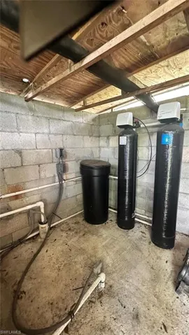 Unfinished below grade area featuring concrete block wall