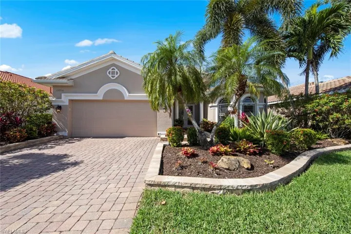 Brick paver drive with pavers bordering landscaping