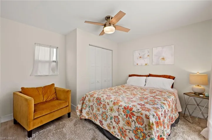 Bedroom with ceiling fan, baseboards, and a closet