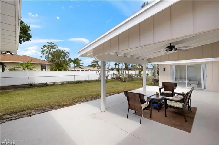 View of patio / terrace featuring fence and a ceiling fan