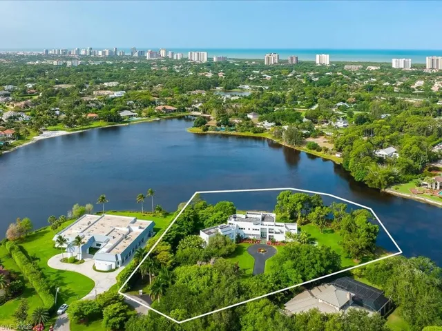 Birds eye view of property with a water view
