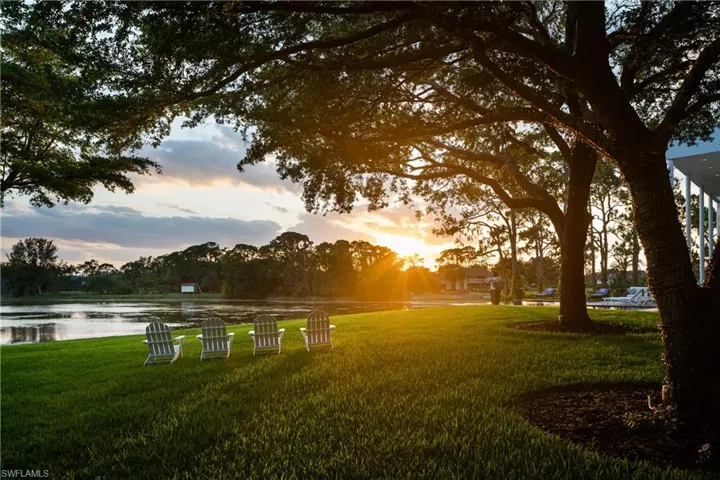 View of community with a lawn and a water view