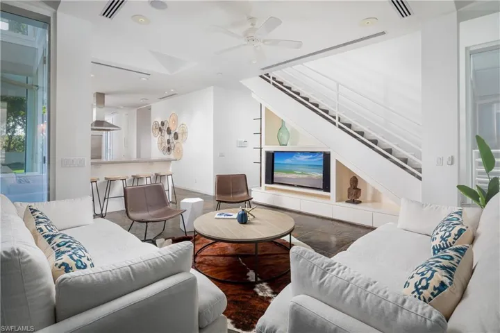 Living room featuring ceiling fan and wood-type flooring
