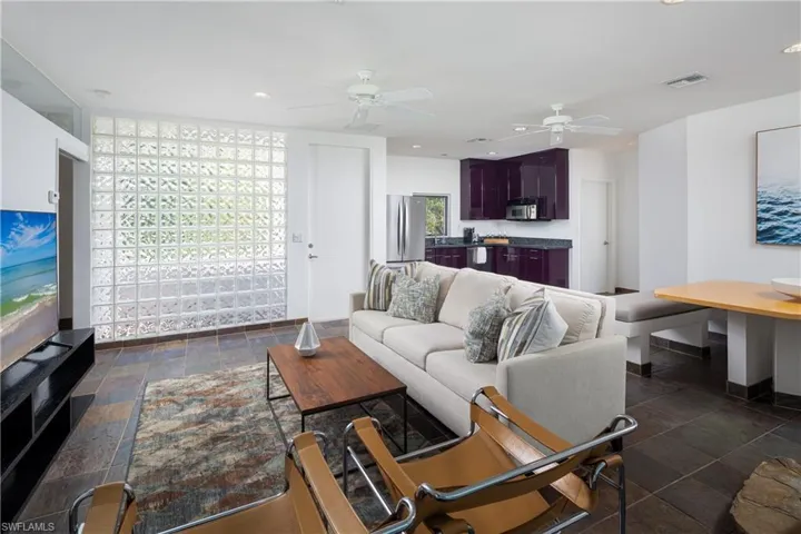 Living room featuring ceiling fan and a healthy amount of sunlight