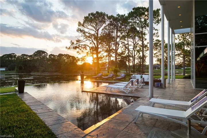 View of dock with an outdoor living space and a water view
