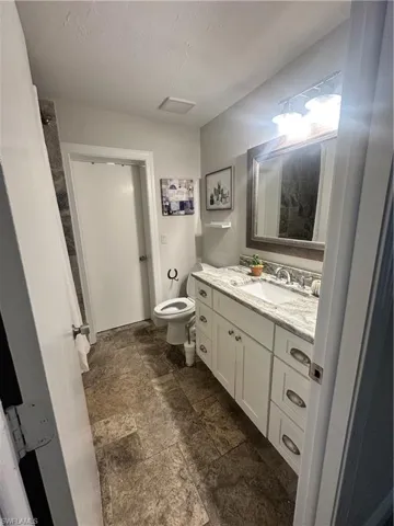 Bathroom featuring vanity and stone tile floors