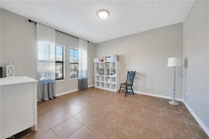 Unfurnished room featuring baseboards and tile patterned floors