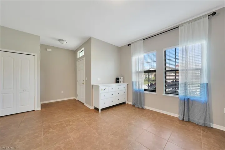 Unfurnished bedroom featuring baseboards and light tile patterned floors