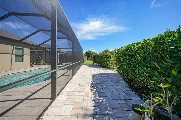 View of patio / terrace featuring glass enclosure and an outdoor pool