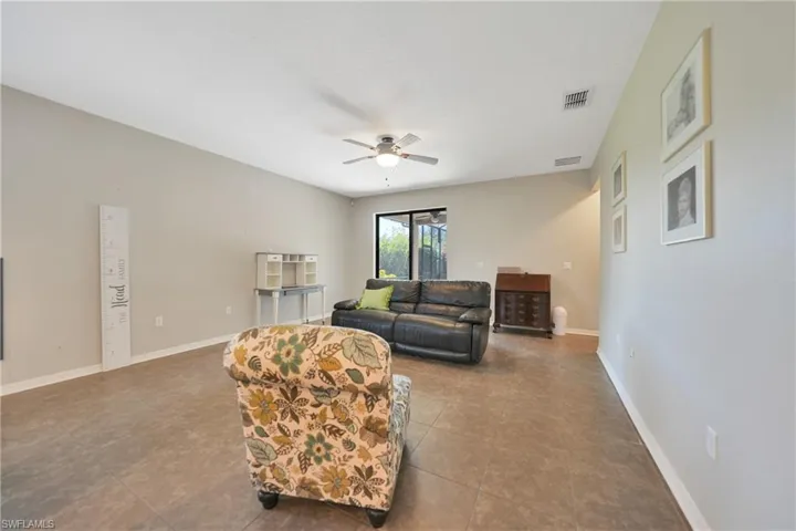 Living room featuring a ceiling fan, baseboards, and visible vents