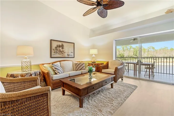 Living room with lofted ceiling and light wood-type flooring