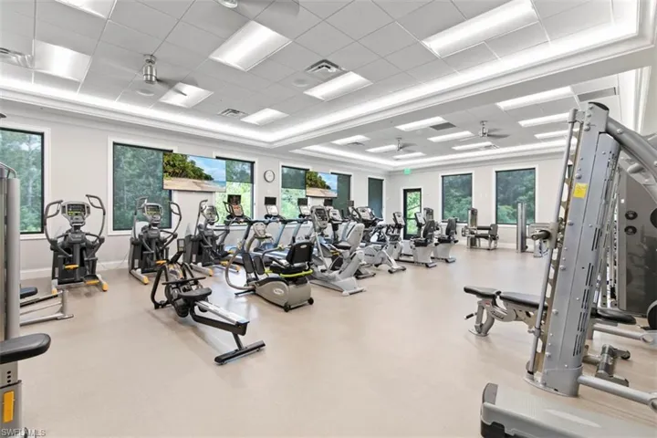 Workout area featuring a drop ceiling and ceiling fan