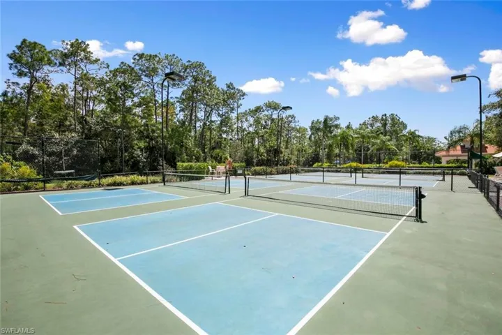 View of tennis court with basketball hoop